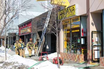 Windsor firefighters respond to a blaze at Havana Smoke Shop & Convenience in the 500-block of Ouellette Ave. downtown, February 23, 2015. (Photo by Mike Vlasveld)