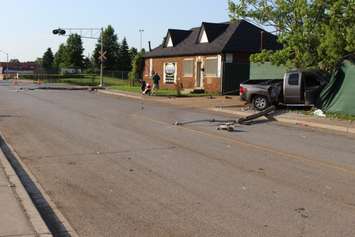 A truck knocks down two hydro poles and smashes through a fence on Drouillard just north of Franklin St., June 10, 2015. (Photo by Jason Viau)