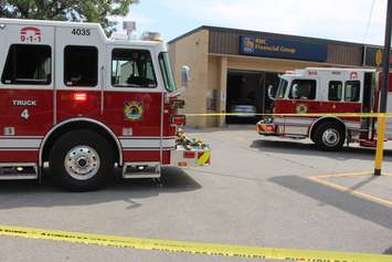 Three people were sent to hospital after a car smashes through the front of an RBC Bank on Huron Church Rd., July 3, 2015. (Photo by Jason Viau)