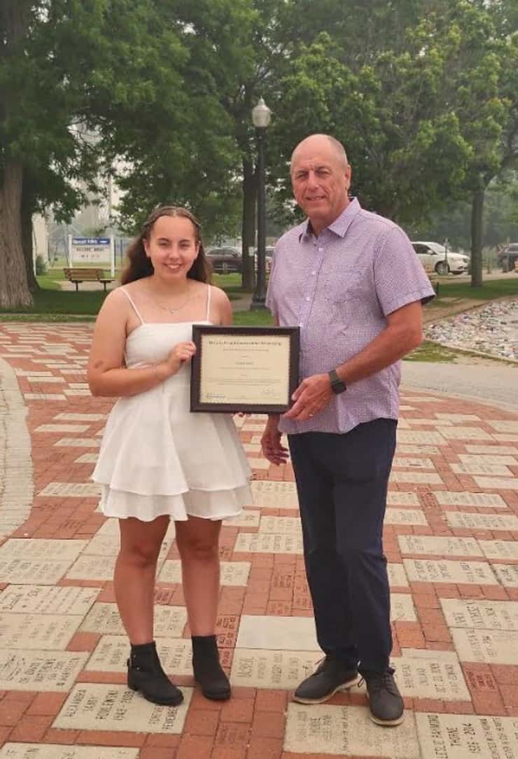 Areya Young is awarded with the Mary Jo Arnold Conservation Scholarship by St. Clair Region Conservation Authority Chair Greg Grimes. July 2026. (Photo courtesy of the SCRCA)