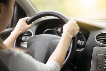 Woman driving car. (Photo courtesy of © Can Stock Photo / fizkes). 