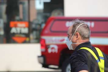 Fire officials wore masks because of thick smoke from the fire at Le Chef Restaurant and Downtown Auto Shop on Wyandotte St. E in Windsor, May 23, 2016. (Photo by Adelle Loiselle)