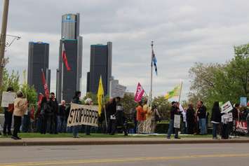 Protesters gather outside the Waterfront Hotel in downtown Windsor during Prime Minister Stephen Harper's visit to the city, May 13, 2015. (Photo by Jason Viau)
