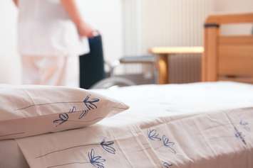 Bed in a long term care home. © Can Stock Photo / stokkete