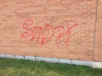 Graffiti on the side of a bank in Bothwell. (Photo courtesy of Chatham-Kent police)