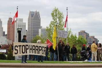 Protesters gather outside the Waterfront Hotel in downtown Windsor during Prime Minister Stephen Harper's visit to the city, May 13, 2015. (Photo by Jason Viau)