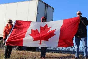 Supporters come out to the Communications Rd. overpass on Hwy. 401 for the repatriation ceremony of fallen veteran and Wheatley native John Gallagher on November 20, 2015. (Photo by Ricardo Veneza)