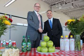 Windsor Mayor Drew Dilkens, left, thanks Rose City Ford owner John Chisholm for his contributions in helping keep the Downtown Windsor Farmers Market open, May 1, 2015. (Photo by Jason Viau)