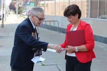 Federal Liberal Party Candidate in Essex Audrey Festeryga talks to Canadian Veteran Larry Costello about what her party will do to benefit veterans, outside of Windsor's former veterans affairs office downtown, September 3, 2015. (Photo by Mike Vlasveld)