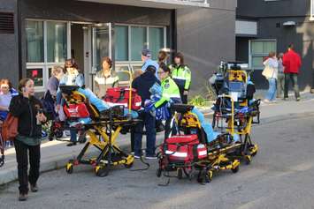 Paramedics assist residents of an apartment building on Rivard Ave. in Windsor after a fire, October 7, 2015.  (Photo by Adelle Loiselle)