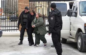 Elizabeth Wettlaufer is escorted into the Woodstock courthouse, January 13, 2017. (Photo by Miranda Chant, Blackburn News)