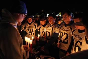 Teammates, friends and family of Michael Matte gather outside of General Amherst High School for a candlelight vigil, November 10, 2014. (photo by Mike Vlasveld)