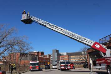 Faculty from Centennial College up on the aerial ladder at CKFES Headquarters. March 29, 2017. (Photo by Natalia Vega)