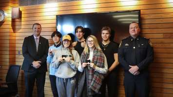 Sarnia police honour five students from Lambton College for stopping an assault from continuing at the school. 

(From left to right) Rob Cardas, Winston Chan, Brielle McInnis, Dylan Climie, Kate Flaningan, Quinton Pluzak, and Chief Norm Hansen. January 2020. (Photo provided by SPS)