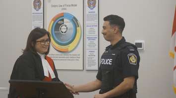 Justice Krista Lynn Leszczynski congratulates Sarnia Cst. Asad Amir during a swearing-in ceremony at the Sarnia Police Tactical and Academic Training Centre. 6 April 2023. (Photo by SarniaNewsToday.ca)
