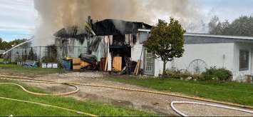 Fire crews respond to a garage fire at 7285 Base Line in Wallaceburg, October 24, 2021. (Photo courtesy of the Chatham-Kent Fire and Emergency Service via Twitter)