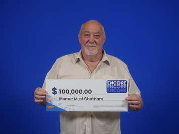 Homer Martin poses with his $100,000 cheque after winning a top prize with an Encore ticket. (Photo courtesy of the OLG)