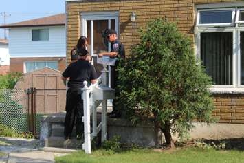 Chatham-Kent firefighters going door-to-door on Timmins Cres., during their post fire reassurance initiative. September 6, 2016. (Photo by Natalia Vega)