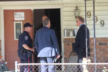 Windsor police officers investigate the 900-block of Pillette Rd. where a gunman was arrested, June 1, 2016. (Photo by Jason Viau)
