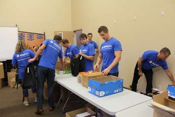 Volunteers filling backpacks with school supplies for local children going back to school. August 29, 2016. (Photo by Natalia Vega)