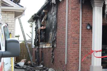 Fire investigators comb through a house on Spago Cres. after a weekend blaze, March 30, 2015. (Photo by Jason Viau)