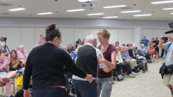 A veteran asks a Parkwood staff member to dance as Walter Ostanek performs polka tunes, July 15, 2016. (Photo by Samuel Gallant)