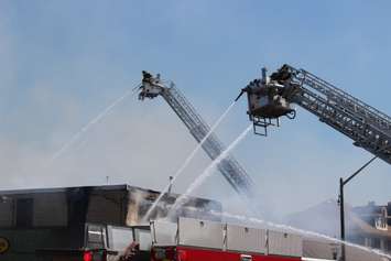Two of three aerial trucks used to fight the fire on Wyandotte St. E in Windsor, May 23, 2016.  (Photo by Adelle Loiselle)
