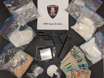 An assortment of drugs, currency, and a weapon seized on January 9, 2023 are shown. Photo provided by Windsor Police/Twitter.