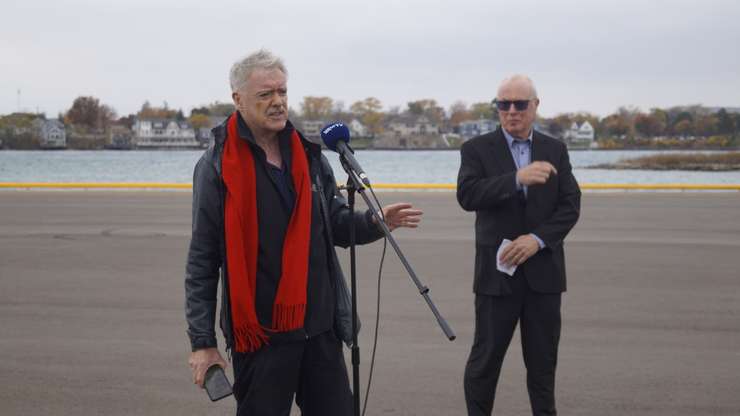 Oversize Load Corridor (OLC) Project Manager Lyle Johnson (right) watches as Sarnia Mayor Mike Bradley makes remarks at the ribbon cutting of the Cestar Dock at Sarnia Harbour. October 31, 2024 Blackburn Media photo by Melanie Irwin.