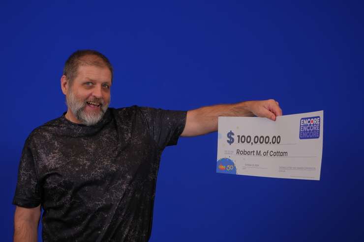 Robert Moore of Cottam with his $100,000 prize cheque at the OLG Prize Centre in Toronto. Photo courtesy Ontario Lottery and Gaming.