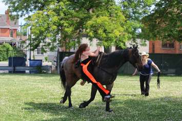 Vollans starts off the show by jumping dife to side over her horse, Bayou. June 12, 2018 (Photo by Greg Higgins)
