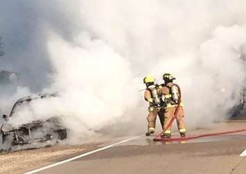 Tecumseh firefighters battle a car fire on Hwy. 3, September 6, 2015. (Photo courtesy of the Tecumseh Fire and Rescue Service via Twitter)