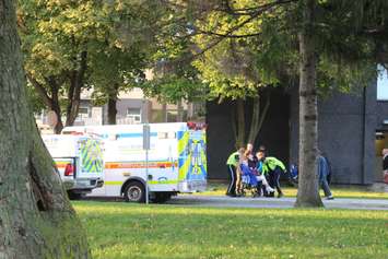 Paramedics help an elderly resident after a fire at an apartment building on Rivard Ave. in Windsor, October 7, 2015.  (Photo by Adelle Loiselle)