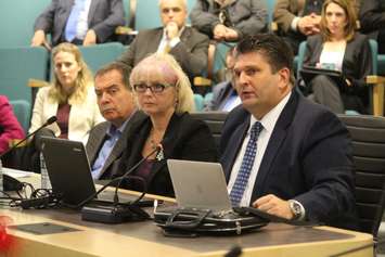 Windsor Regional Hospital CEO David Musyj (right), CEO of Hotel-Dieu Grace Healthcare Janice Kaffer (middle) and Planning and Services Steering Committee Co-Chair David Cooke (left) speak to Essex County Council, December 16, 2015. (Photo by Mike Vlasveld)