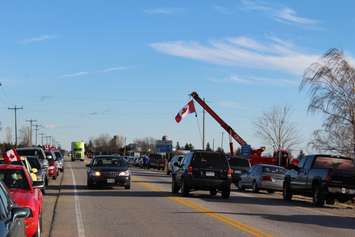 Supporters come out to the Communications Rd. overpass on Hwy. 401 for the repatriation ceremony of fallen veteran and Wheatley native John Gallagher on November 20, 2015. (Photo by Ricardo Veneza)