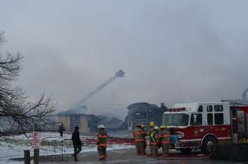Firefighters use aerial ladder to douse hotspots (blackburnnews.com photo)