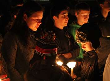 Teammates, friends and family of Michael Matte gather outside of General Amherst High School for a candlelight vigil, November 10, 2014. (photo by Mike Vlasveld)