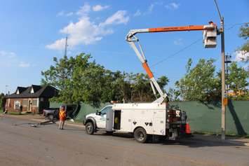 A truck knocks down two hydro poles and smashes through a fence on Drouillard just north of Franklin St., June 10, 2015. (Photo by Jason Viau)