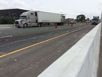 Emergency responders close Hwy 401 west of Walker Rd. after a crash involving two semi trucks, June 18, 2015. (Photo by Jason Viau)
