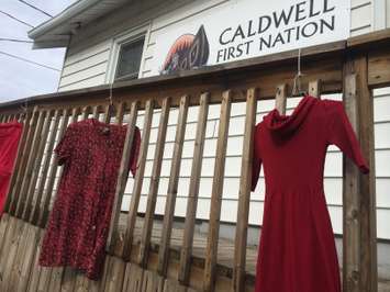 Red dresses hang outside the Caldwell First Nation office in Leamington on May 20, 2015. (Photo by Ricardo Veneza)