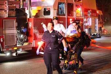 Paramedics transport a man to hospital after a fire at 528 Church St., May 6, 2015. (Photo by Jason Viau)