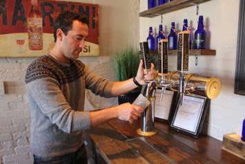 Brew co-founder Jordan Goure pours a glass of Proper Lager, December 2014. (Photo by Mike Vlasveld)