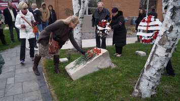 Red flowers were laid at Sarnia's Firefighters' Memorial Garden on East St. Thursday for the National Day of Mourning. April 28, 2016 (BlackburnNews.com Photo by Briana Carnegie)