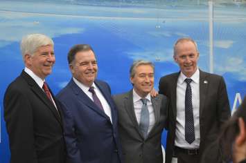 Michigan Governor Rick Snyder, left, WDBA board chairman Dwight Duncan and federal Minister of Infrastructure and Communities Francois-Philippe Champagne pose for photos at the official opening of construction for the Gordie Howe International Bridge in Windsor, October 5, 2018. Photo by Mark Brown/Blackburn News.