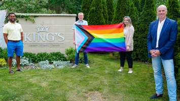 King’s Board of Directors Chair Kapil Lakhotia, LGBTQ2S+ advisory group member Thomas Gray, Holly Clarke, the President of King's University College Students' Council, and Dr. David Malloy, the Principal of King’s University College, unveil the Pride flag that will fly at King's