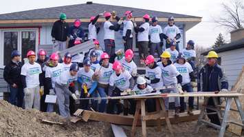 The Sarnia Sting helps with construction of Habitat for Humanity's latest build. December 2, 2014 (BlackburnNews.com photo by Jake Jeffrey)
