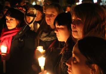 Teammates, friends and family of Michael Matte gather outside of General Amherst High School for a candlelight vigil, November 10, 2014. (photo by Mike Vlasveld)