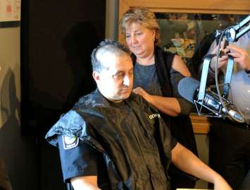 CHOK's Sue Storr shaves Constable John Sottosanti's head live on air to kick of the Shave For The Brave Event.