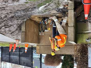 Workers use a crane outside Sarnia Police headquarters. 4 April 2023. (Photo by Melanie Irwin)