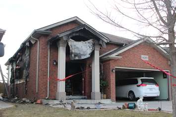 Fire investigators comb through a house on Spago Cres. after a weekend blaze, March 30, 2015. (Photo by Jason Viau)